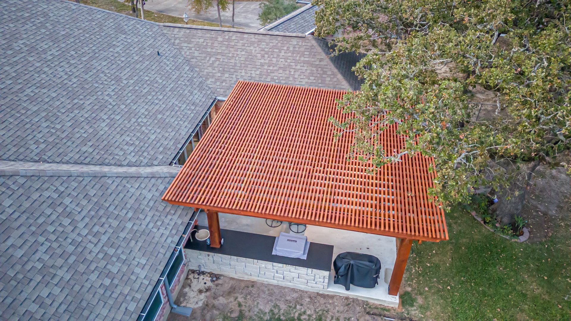 An aerial view of a house with a red roof.