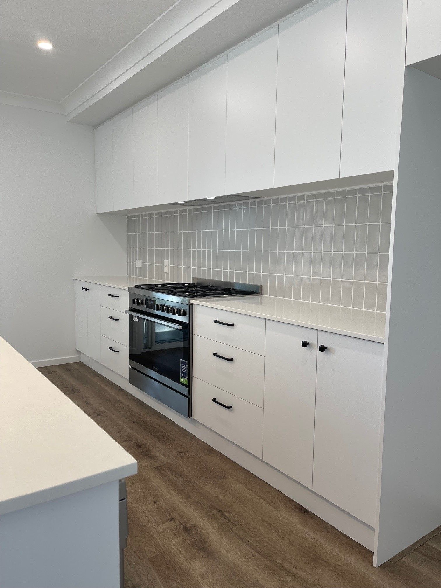 Custom white kitchen cabinetry with soft-close drawers – Brisbane project