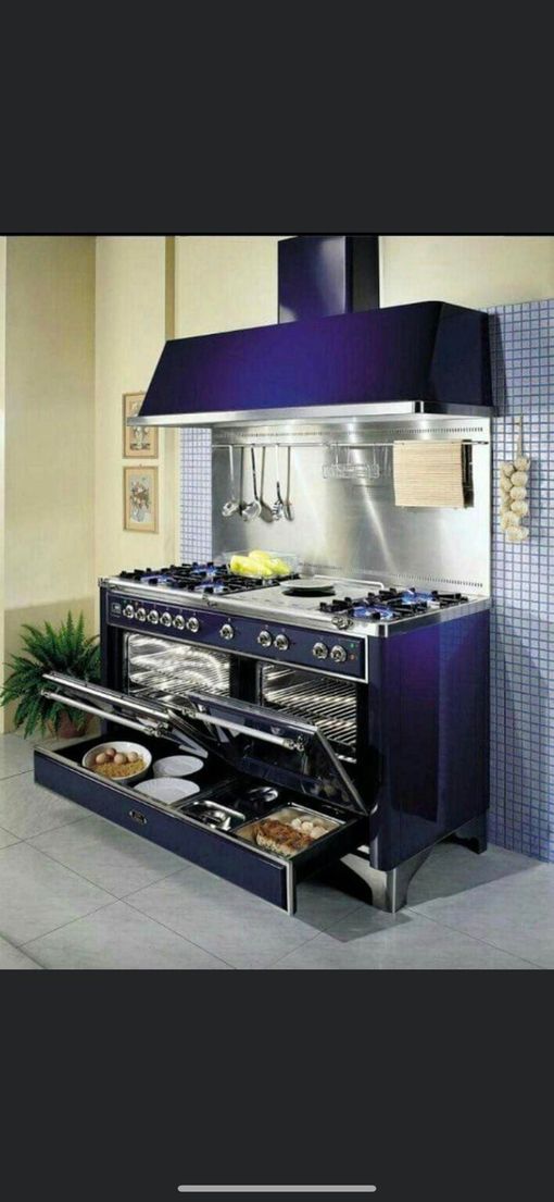 Modern stainless-steel outdoor kitchen with purple hood and cabinets on a patio