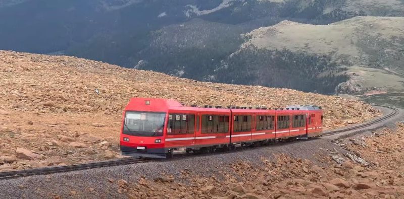 Pikes Peak Cog Railway train ascending the summit outside Colorado Springs CO