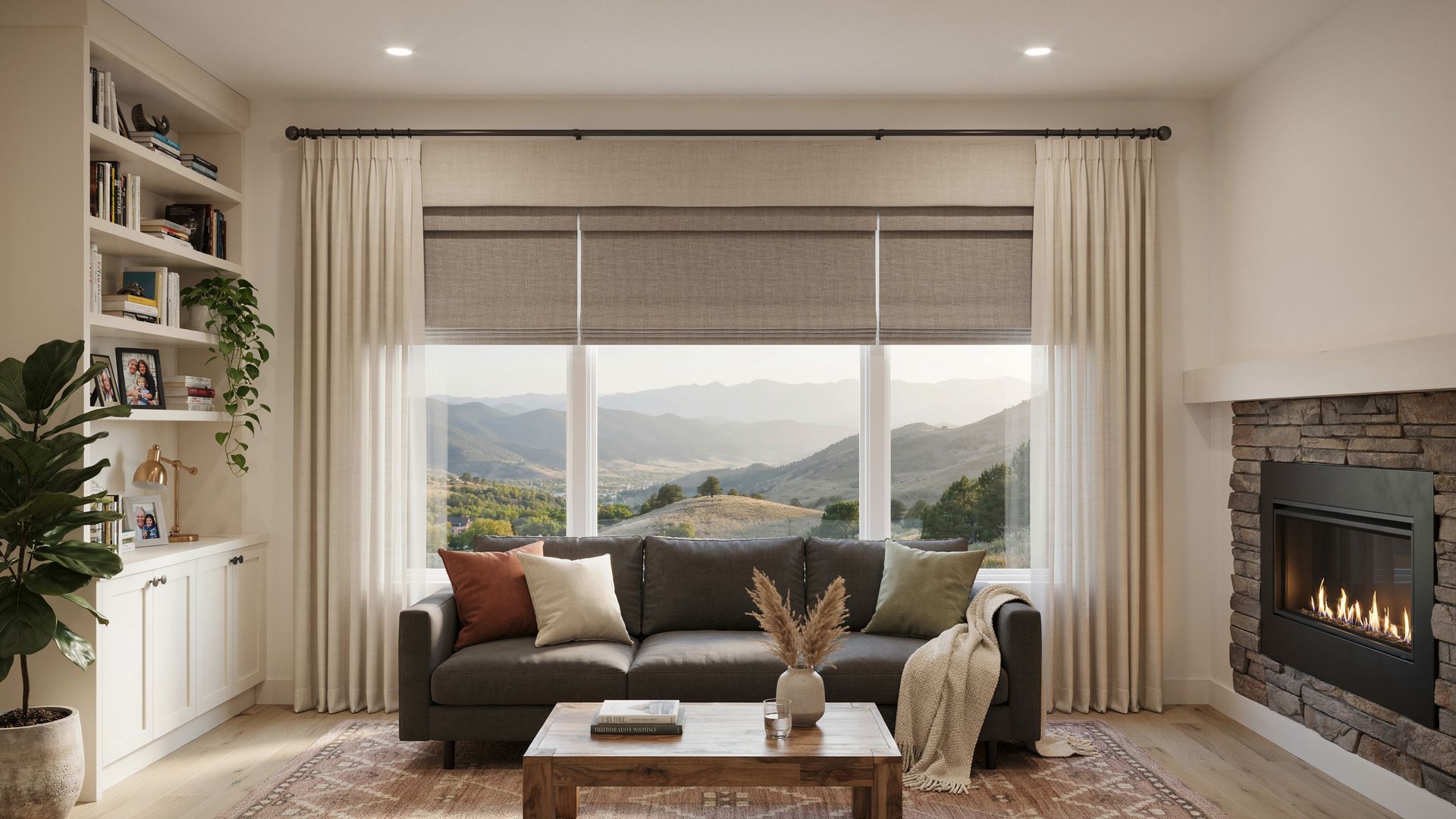 Cozy living room with large window, sectional sofa, coffee table, fireplace, and layered window treatments.