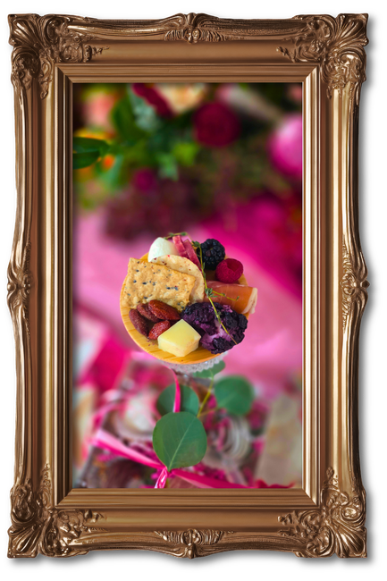 Dessert tart with berries in a decorative gold frame on a pink background