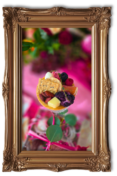 Dessert tart with berries in a decorative gold frame on a pink background
