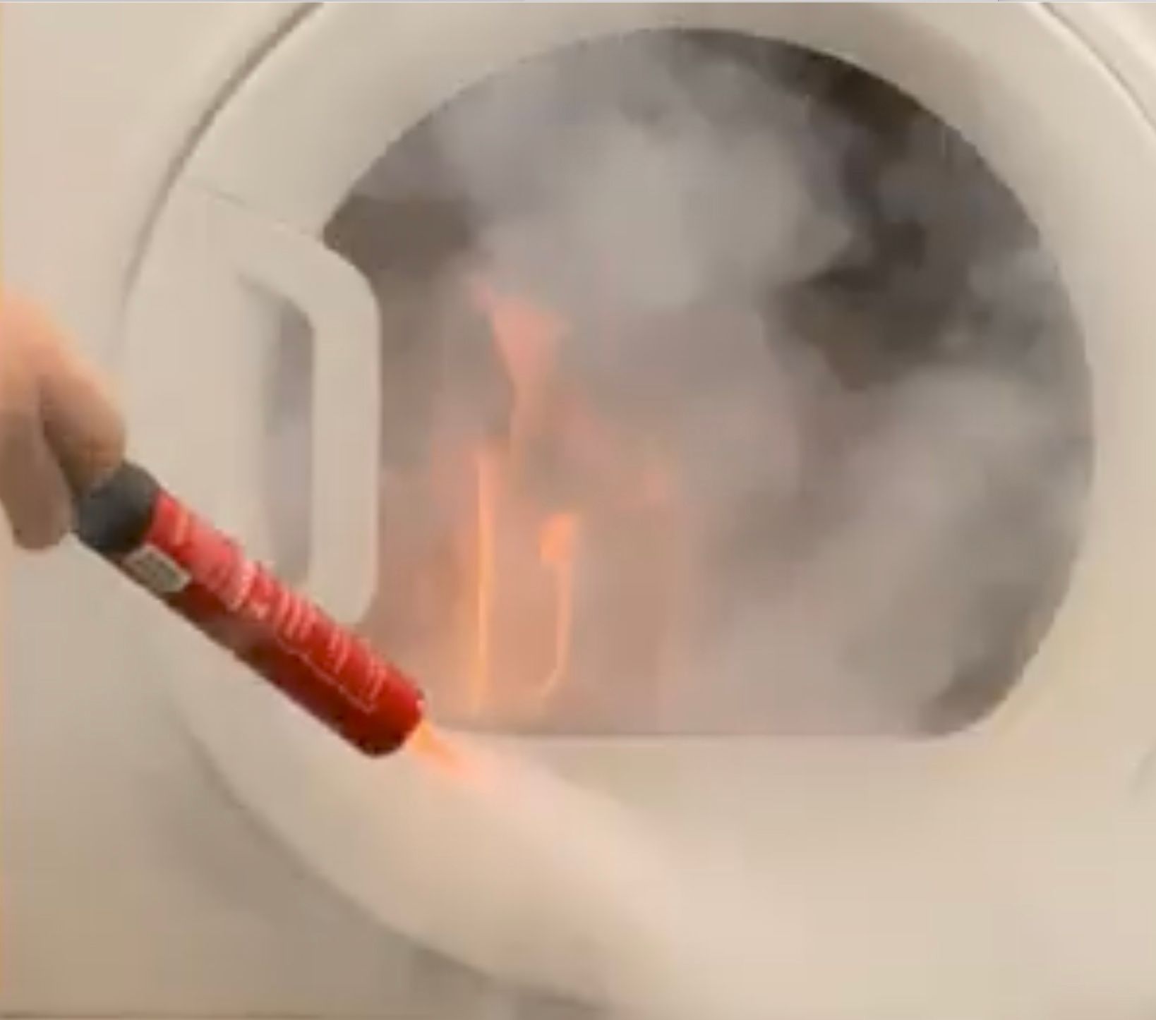 Fire safety stick being used on tumble dryer fire