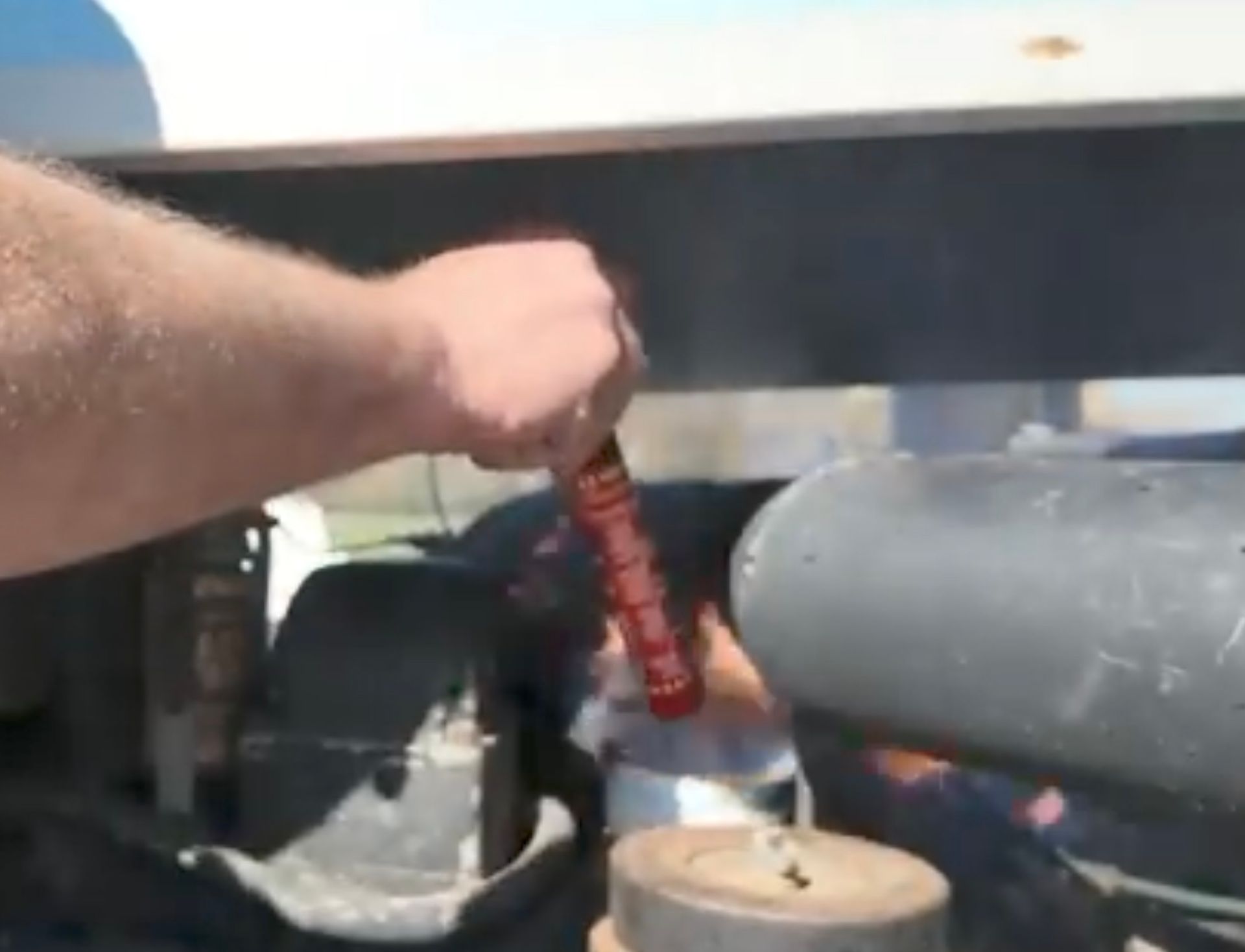 50 second fire safety stick being used on tractor engine