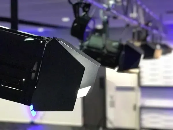 A bunch of lights are hanging from the ceiling in a room.