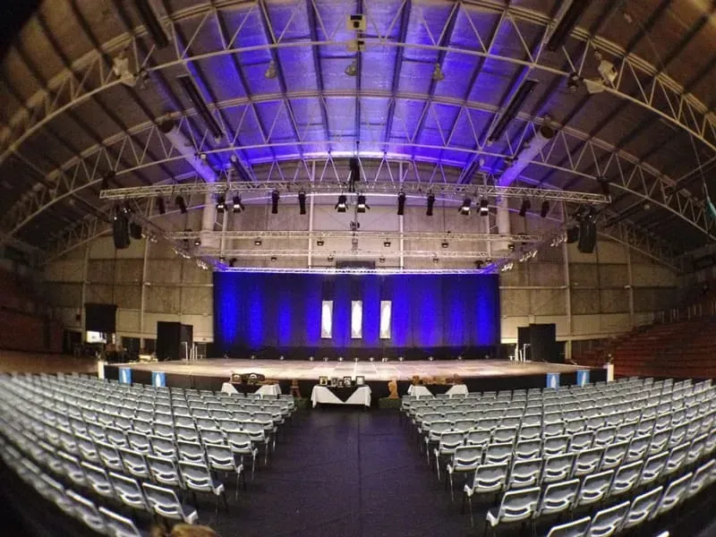 A large auditorium with rows of seats and a stage