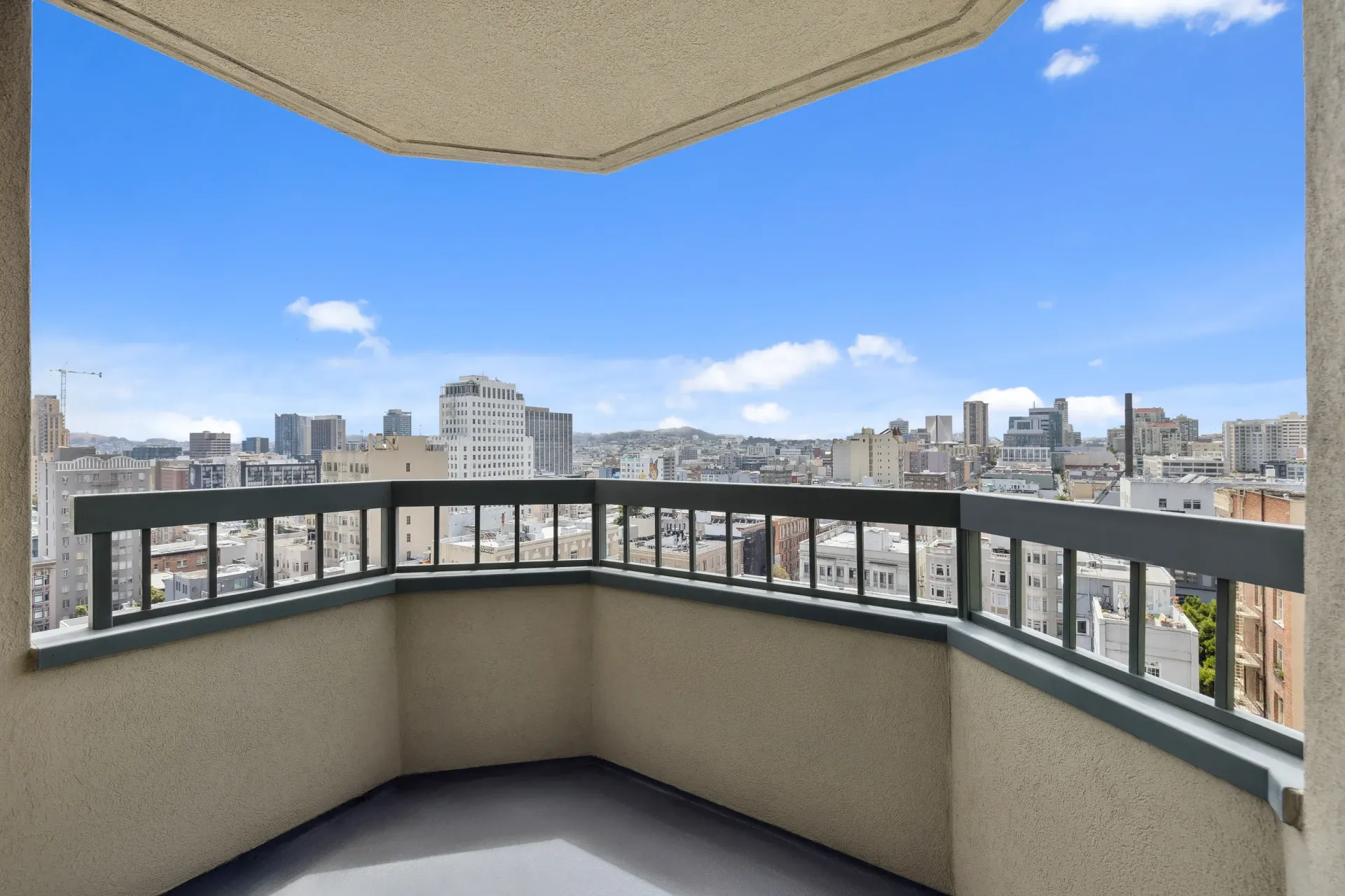 Balcony with railing overlooking a city skyline and blue sky at Tower 737, offering apartments in San Francisco, CA.