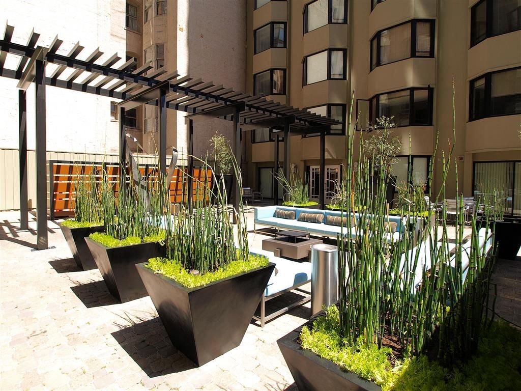 Outdoor apartment community courtyard with modern seating, planters, and a pergola at Tower 737, offering apartments in San Francisco, CA.