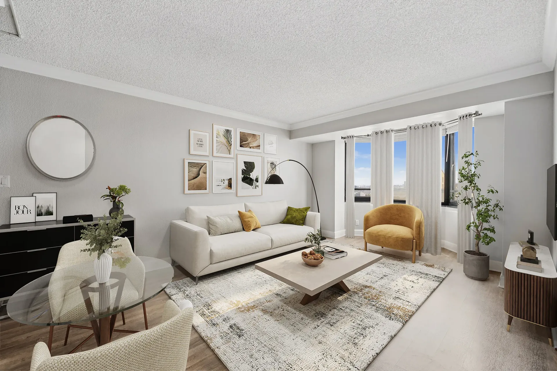 Living room in a modern apartment with a light sofa, glass dining table, and a large window with curtains at Tower 737, offering apartments in San Francisco, CA.