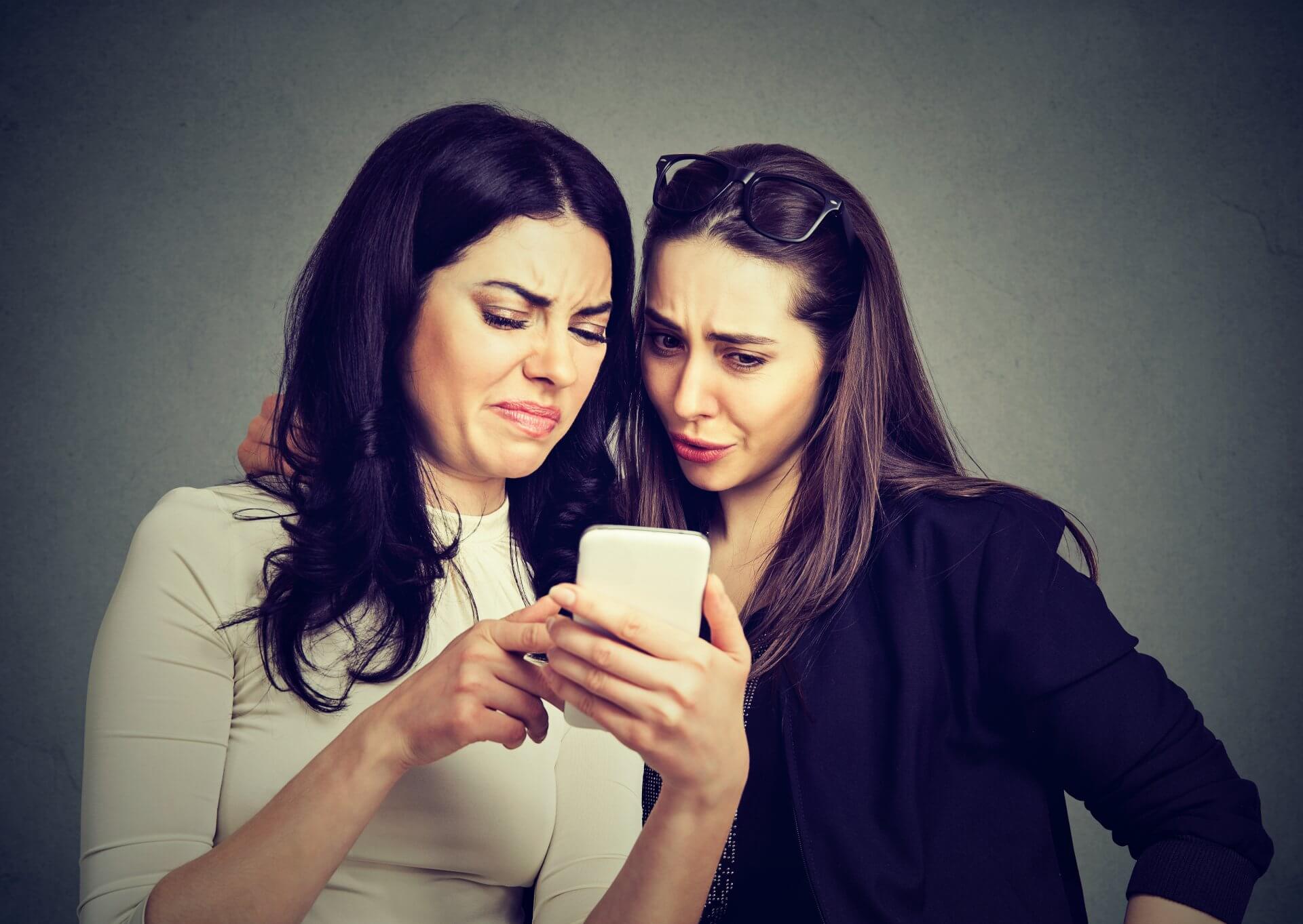 Two women looking at products reviews before making a purchase.