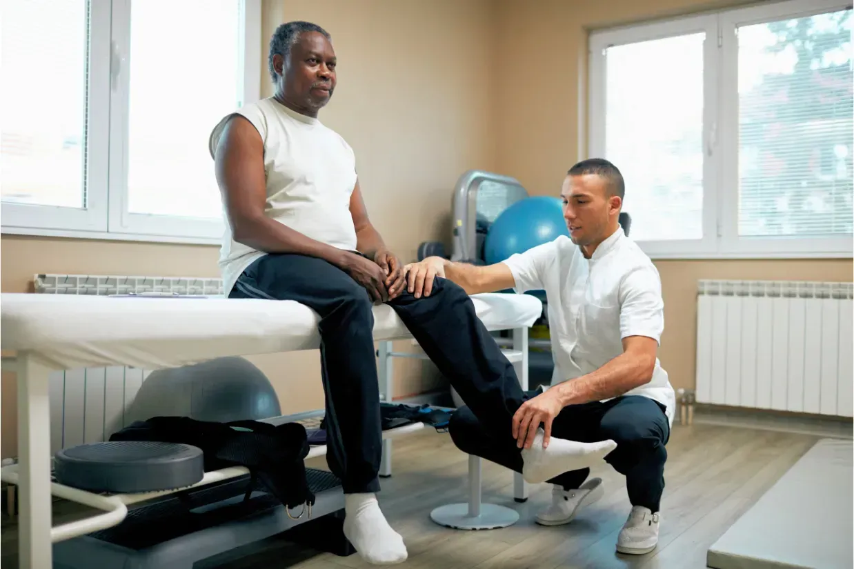 Physical therapist helping a patient recover after orthopedic knee surgery