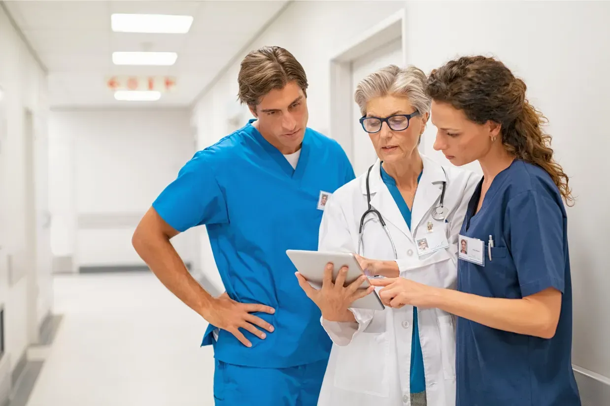 Orthopedic surgeon and rehabilitation team reviewing a patient's post-operative recovery plan