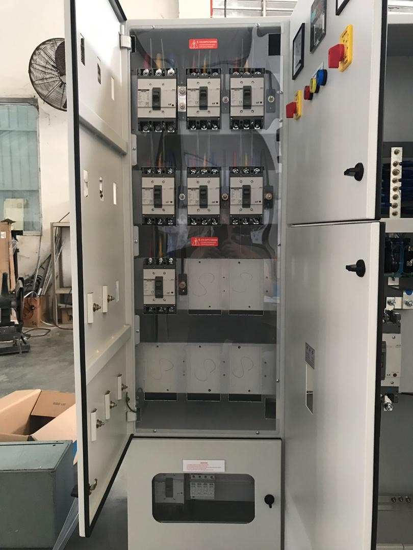 Open electrical panel with multiple circuit breakers and controls.
