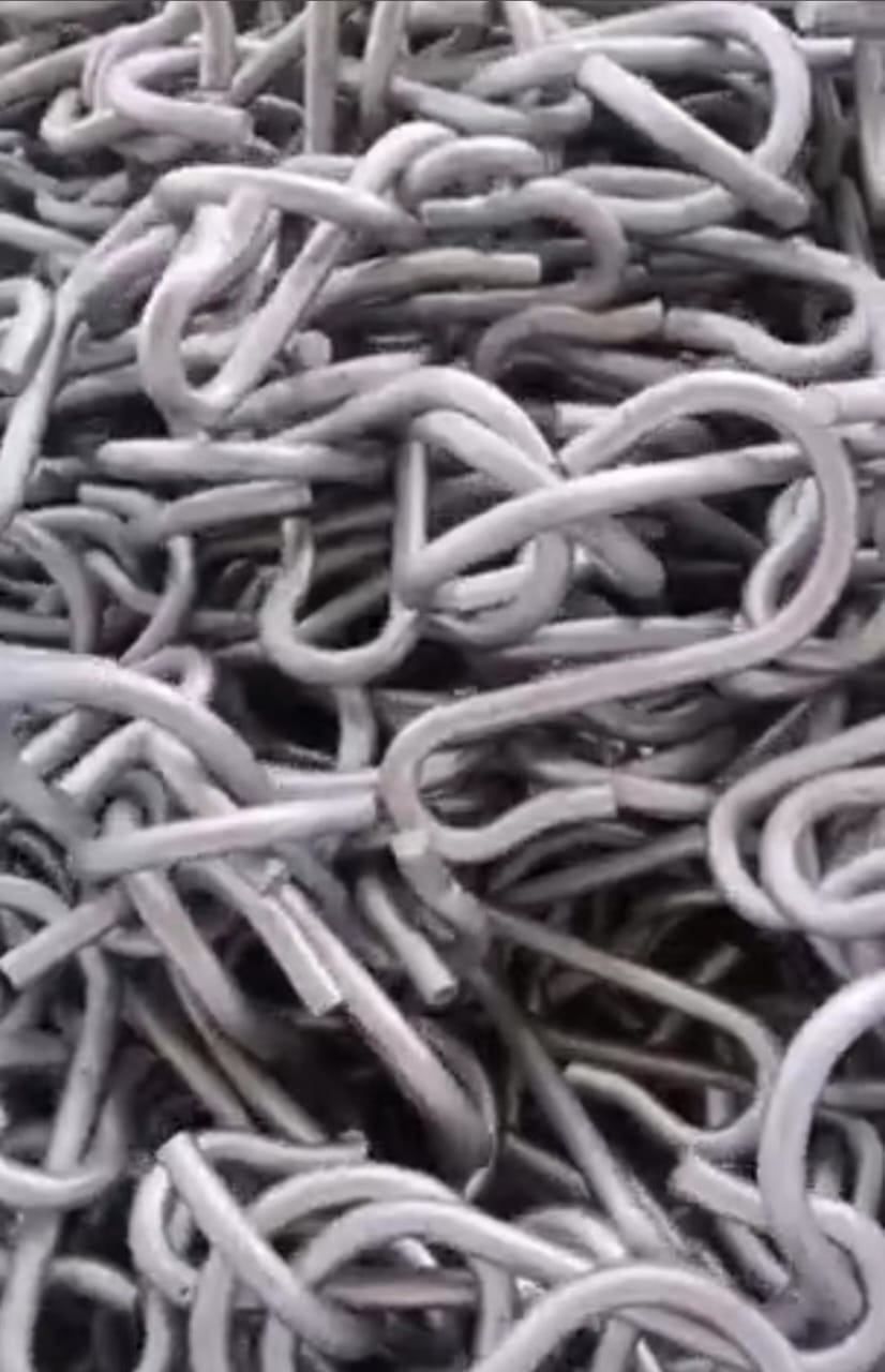 Pile of gray, metal hooks, intertwined and tangled.