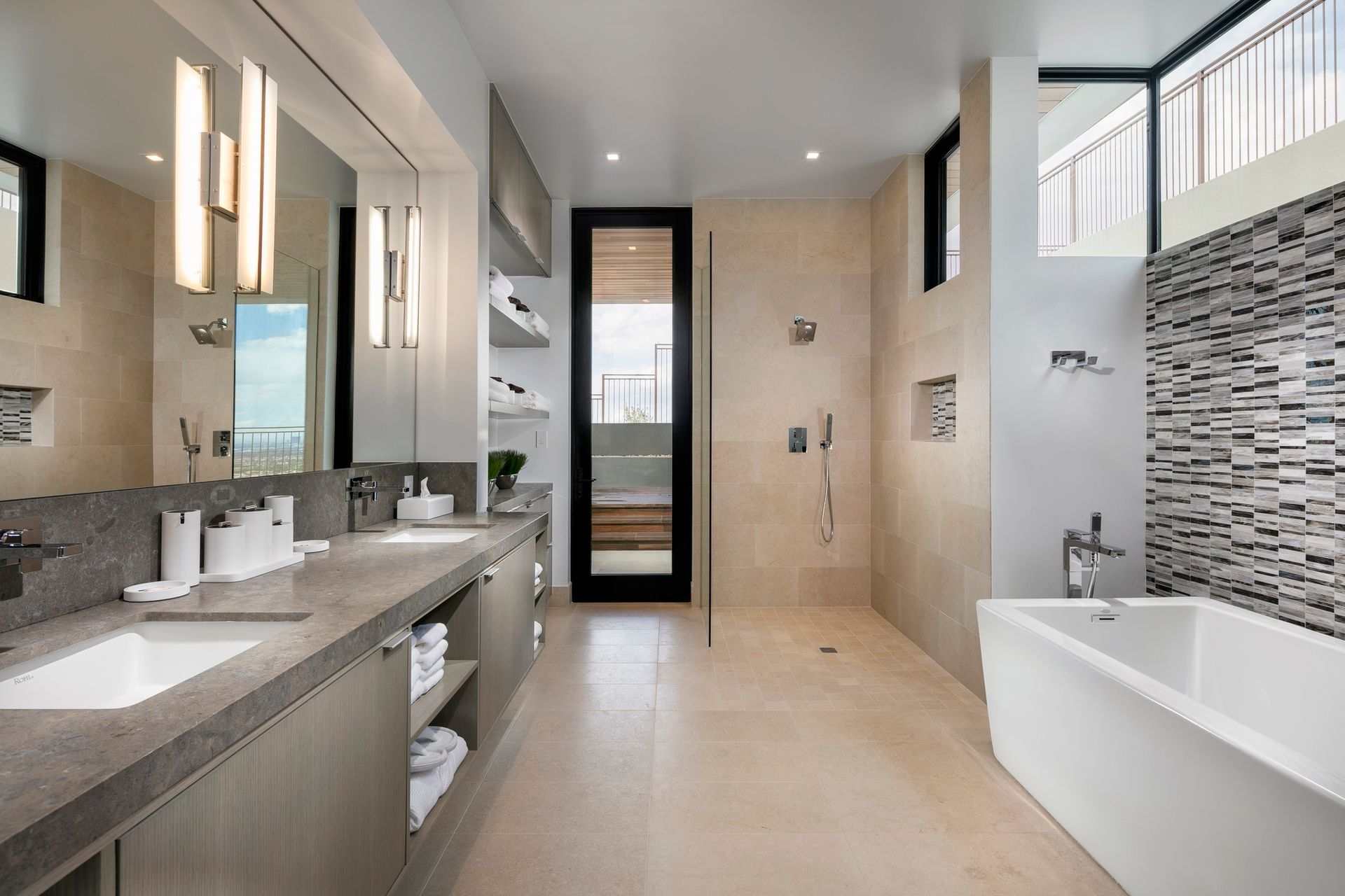 A bathroom with two sinks , a tub , and a walk in shower.