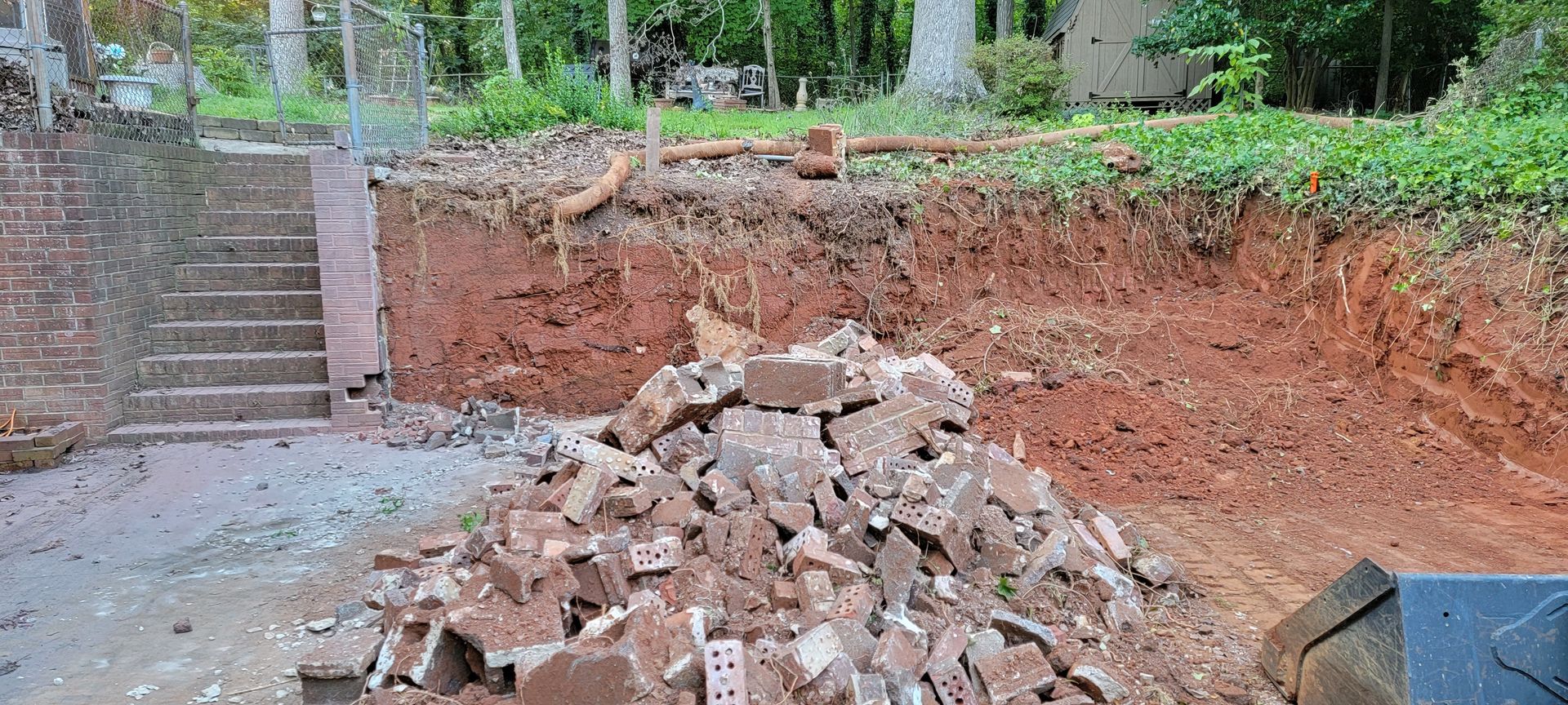 A pile of bricks is sitting on top of a pile of dirt.