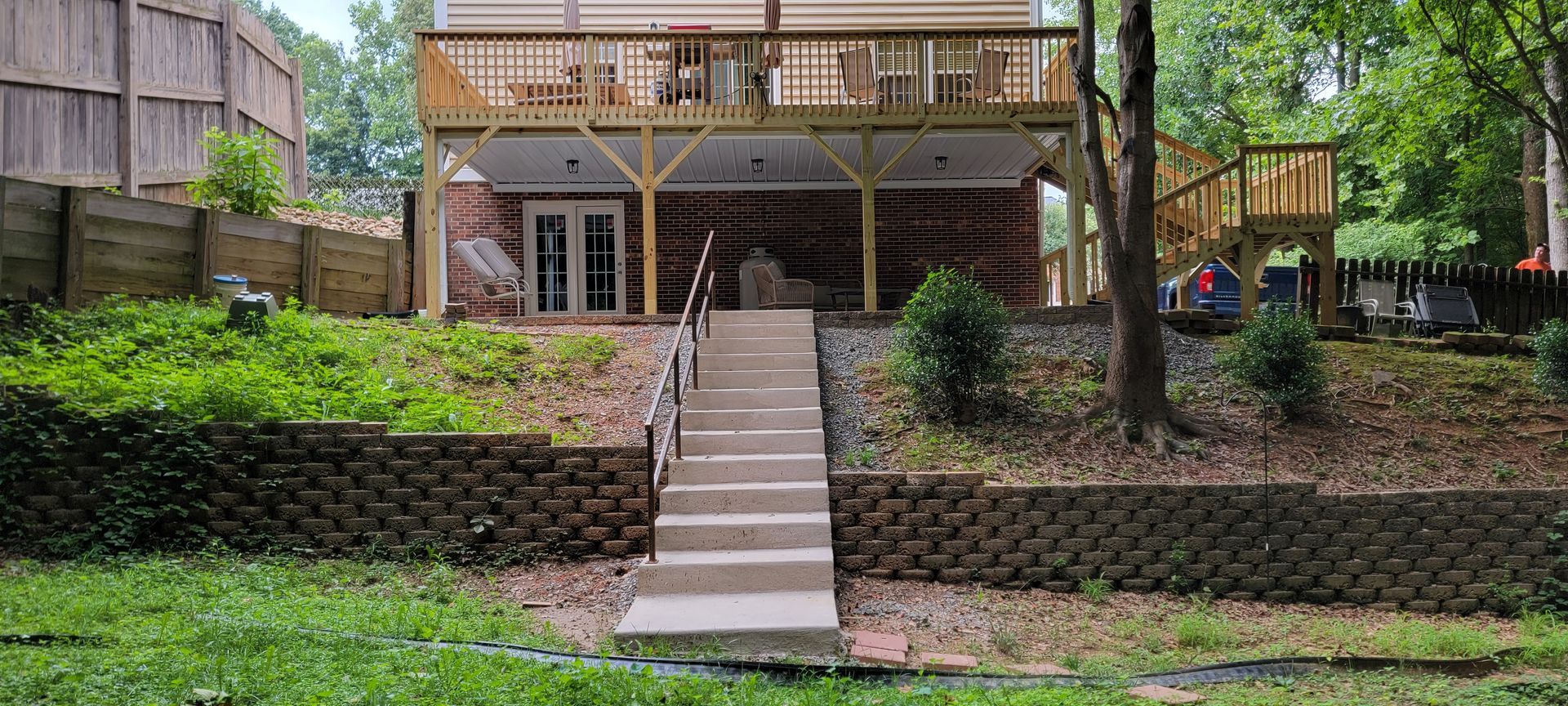 A house with a large deck and stairs leading up to it.