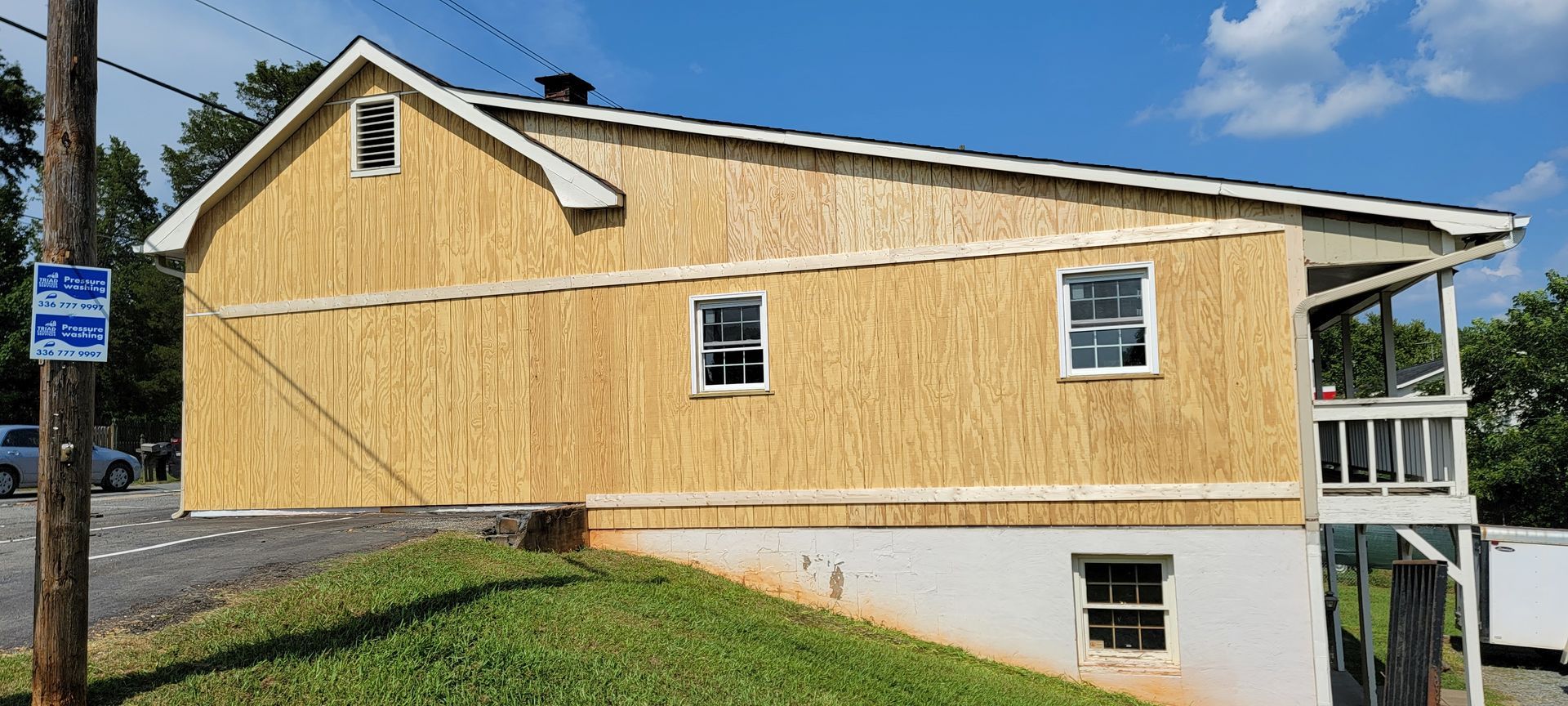 The side of a house with a lot of windows is being built.