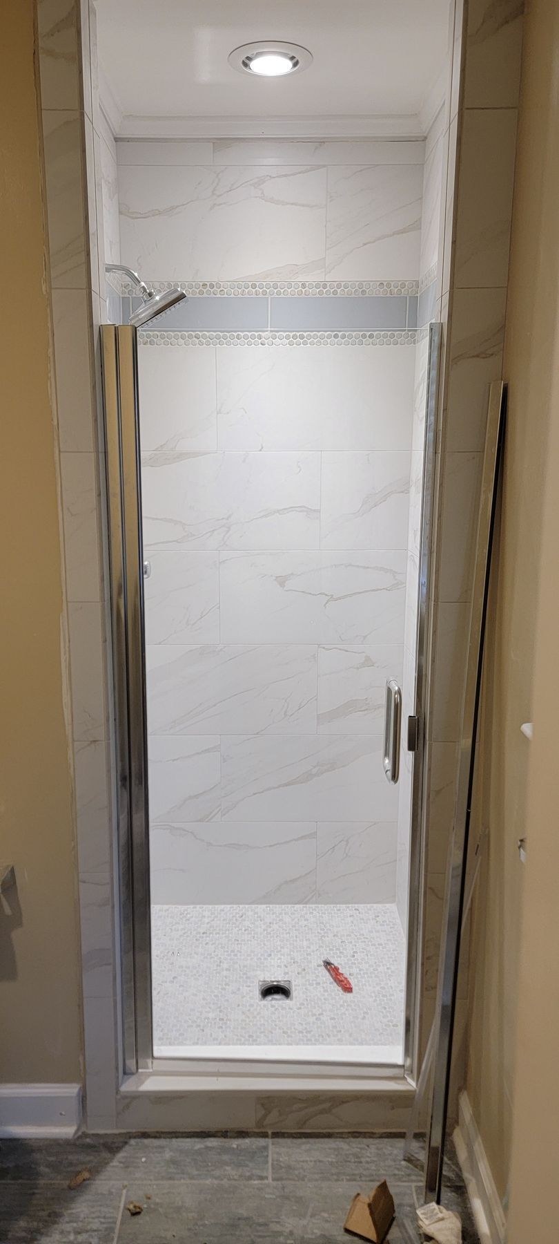 A shower stall is being built in a bathroom.