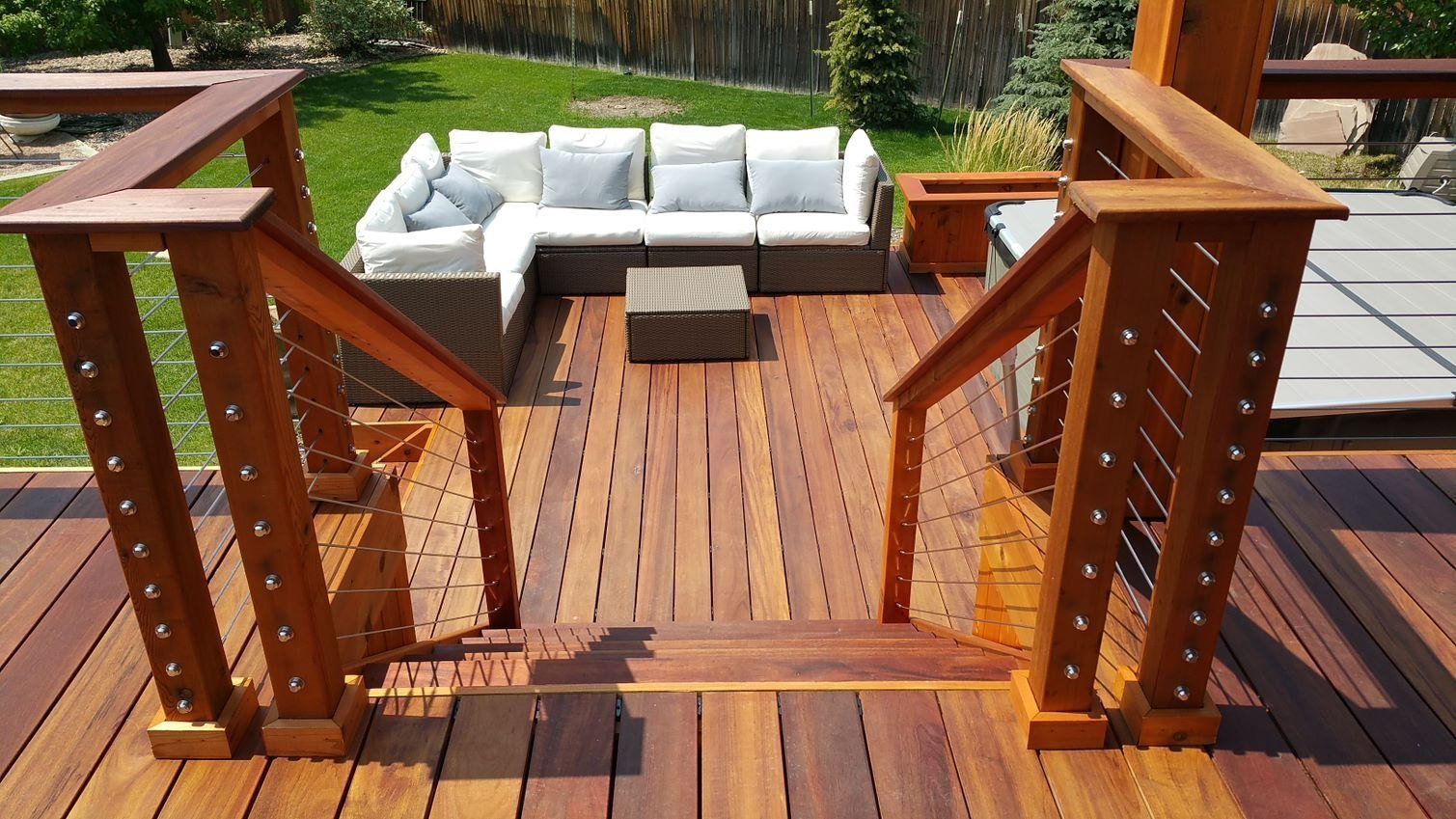 A wooden deck with stairs and a couch on it