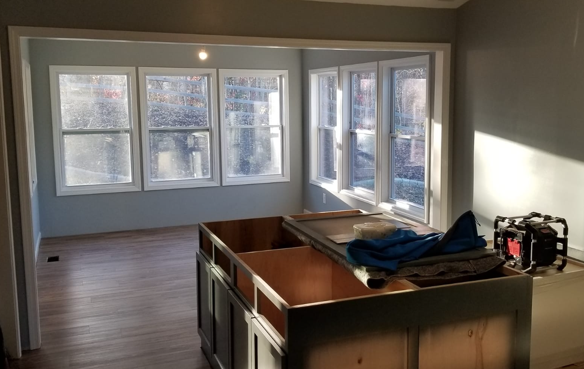 A kitchen under construction with a large island in the middle of the room.