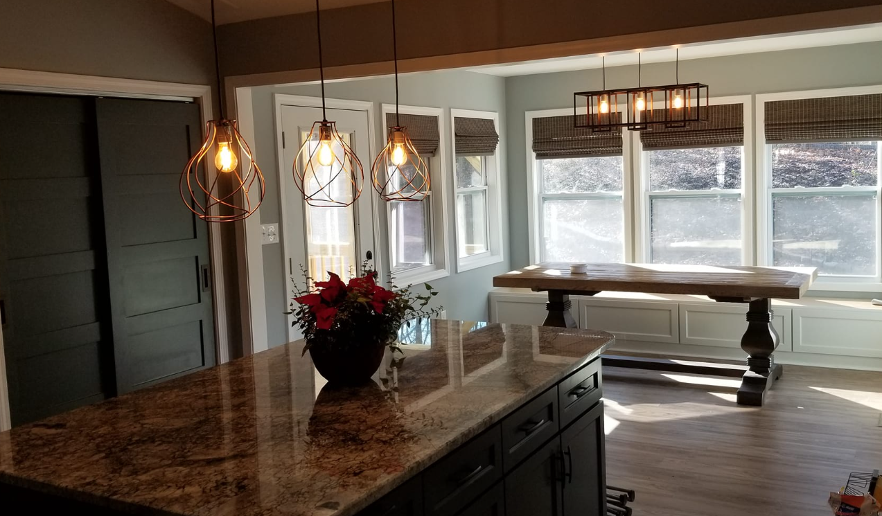 A kitchen with a large island and a table