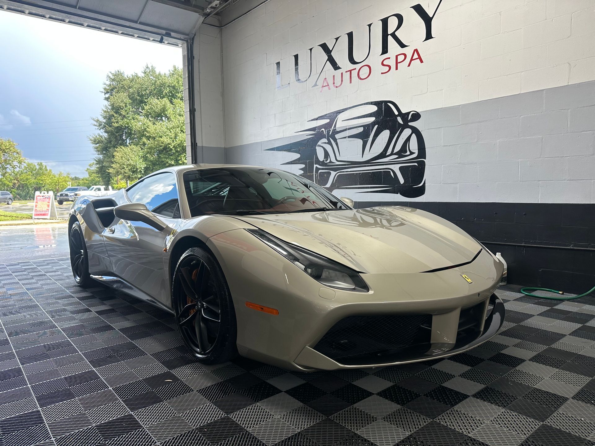 A beige Ferrari parked inside a 