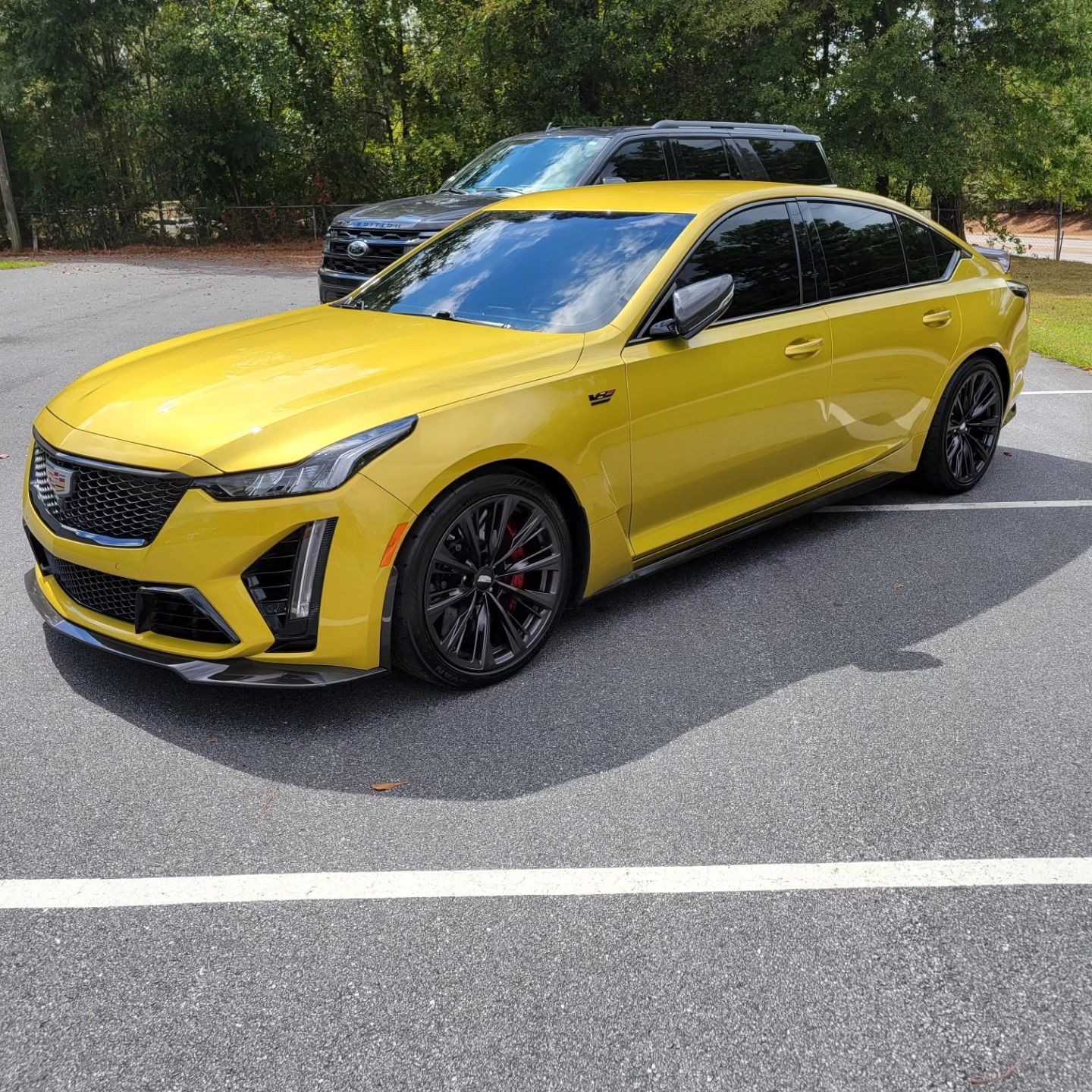 Yellow luxury sedan with professional window tint.