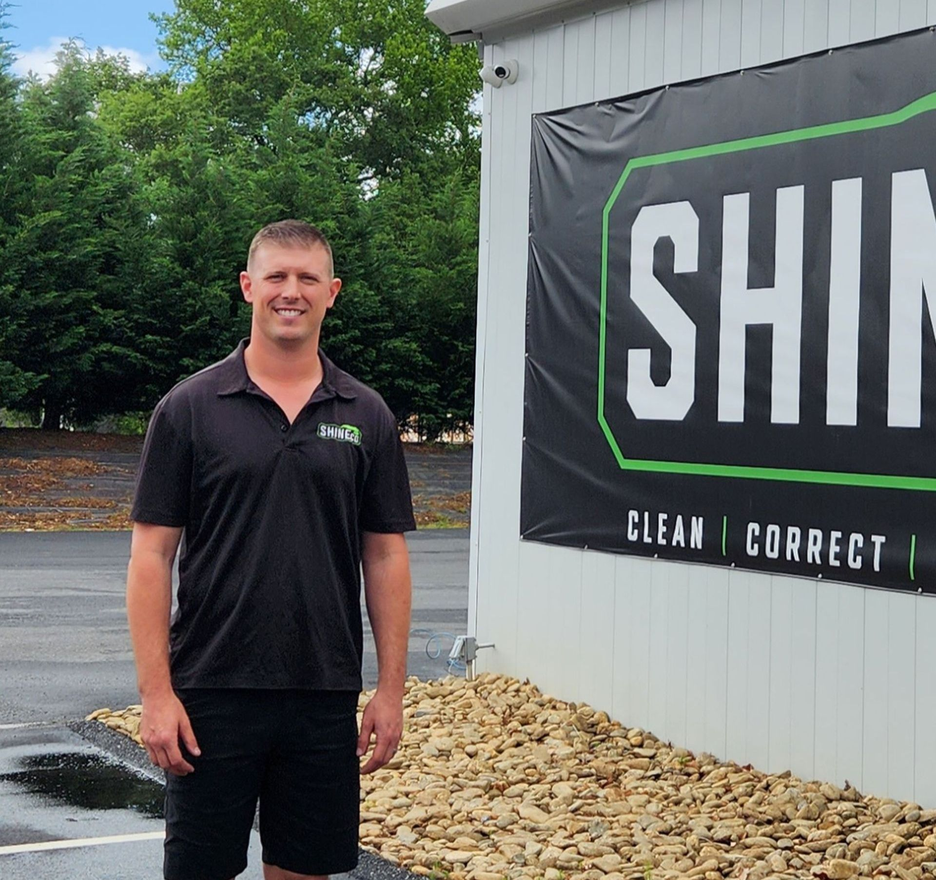 Thomas Kyle Simpson, owner of ShineCo LLC, standing outside ShineCo automotive detailing shop