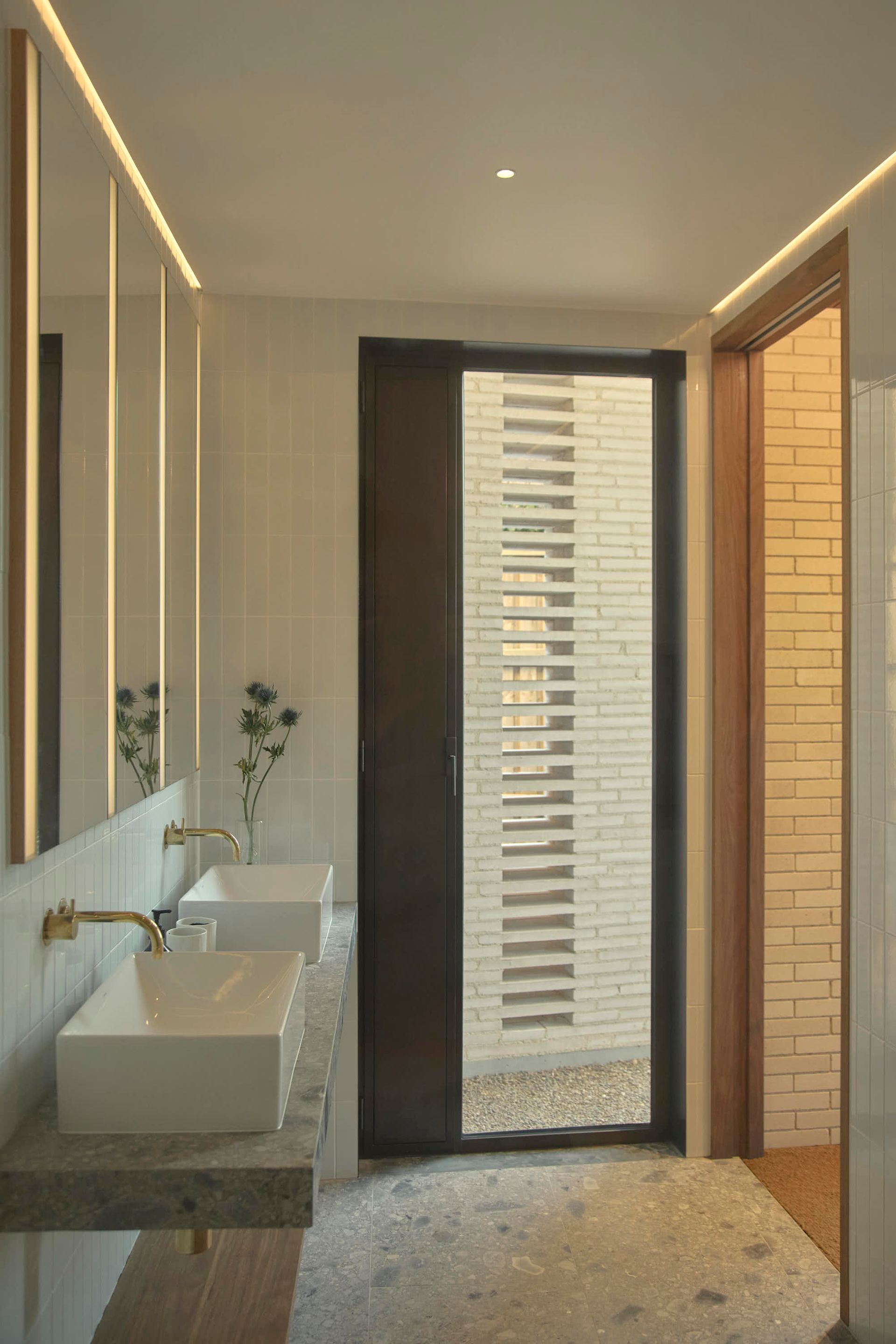 Modern bathroom with a double sink, large glass door, and neutral tones — BSpoke Cabinet Making & Joinery in Unanderra, NSW