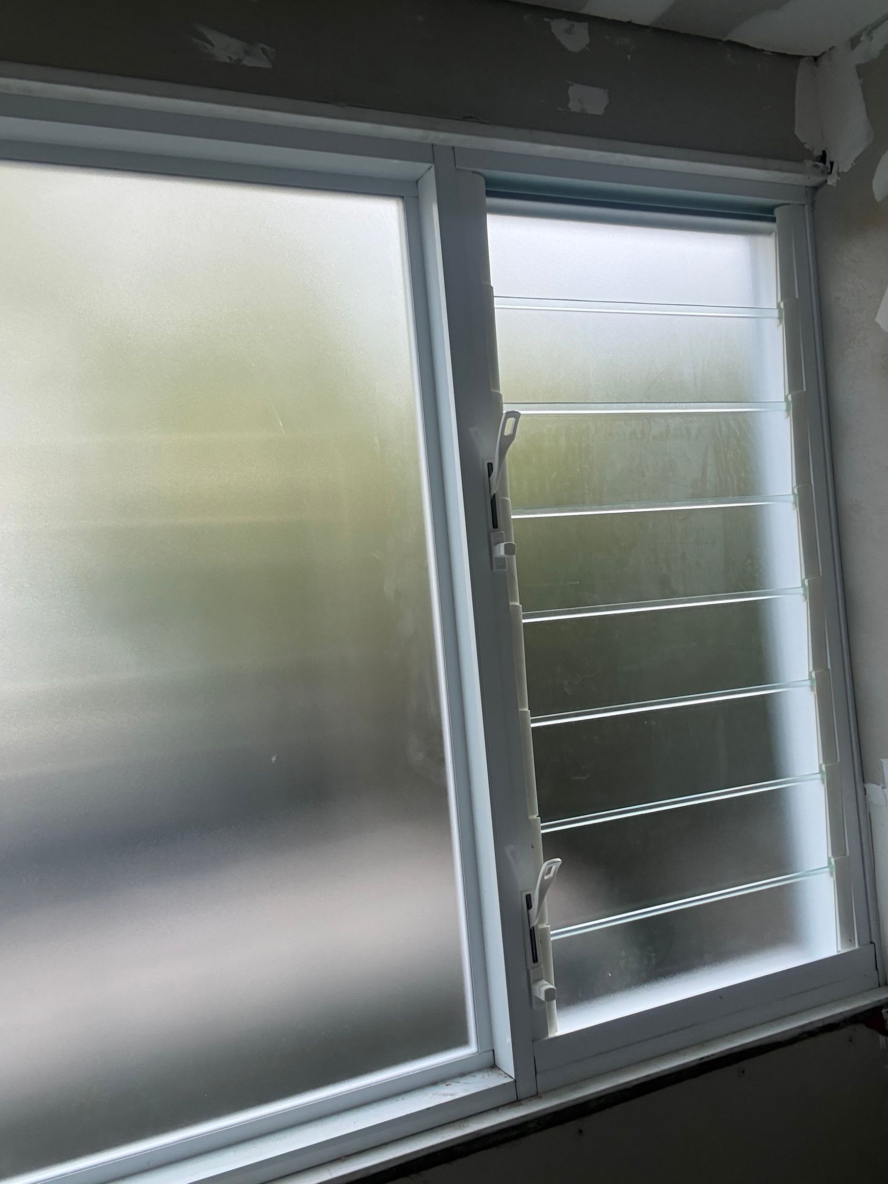 Frosted window with a sliding glass pane and horizontal blinds beside it — Kracken Windows and Doors In Terrey Hills, NSW