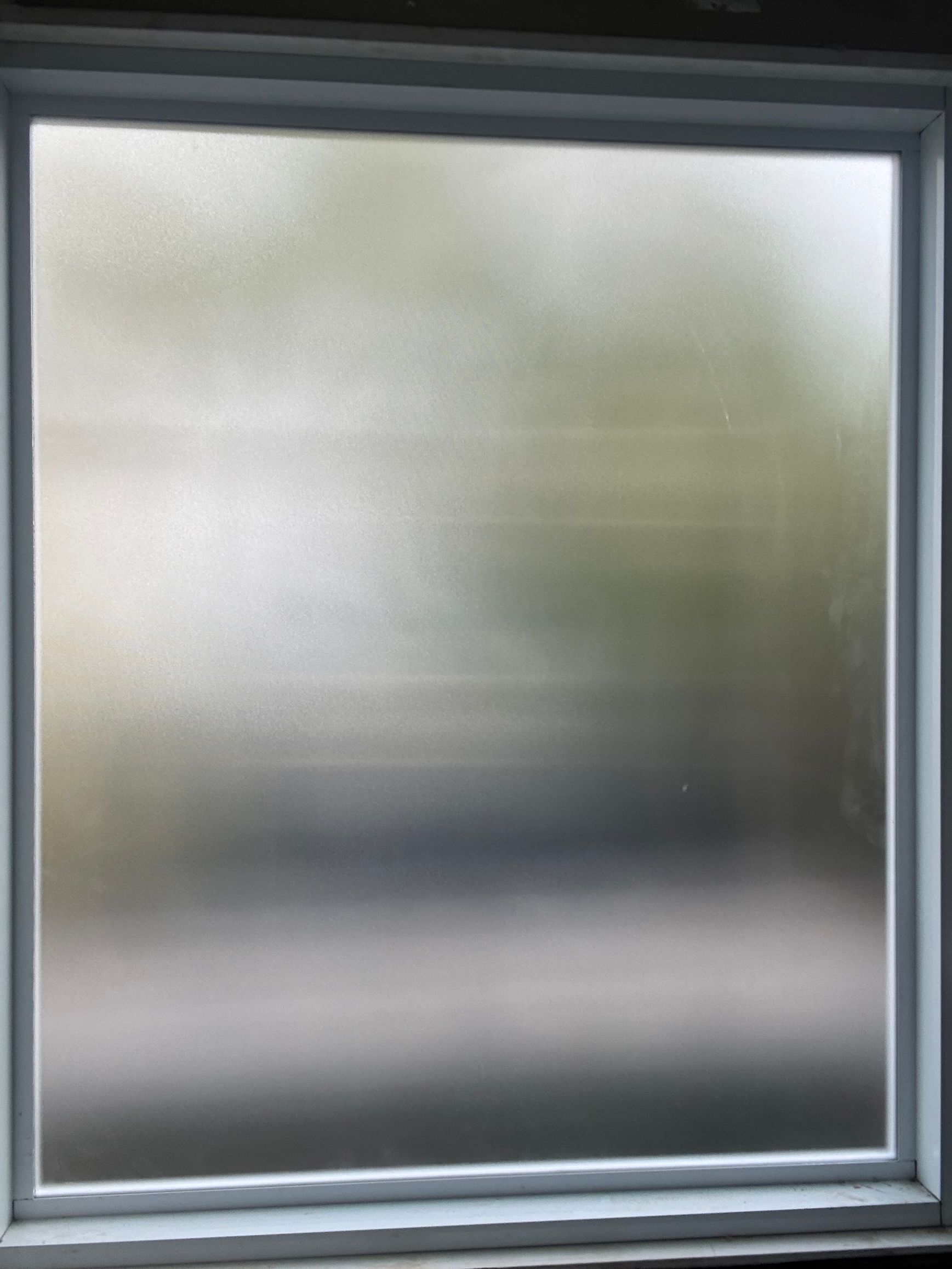 Frosted glass window with a gray frame and blurred view outside — Kracken Windows and Doors In Terrey Hills, NSW