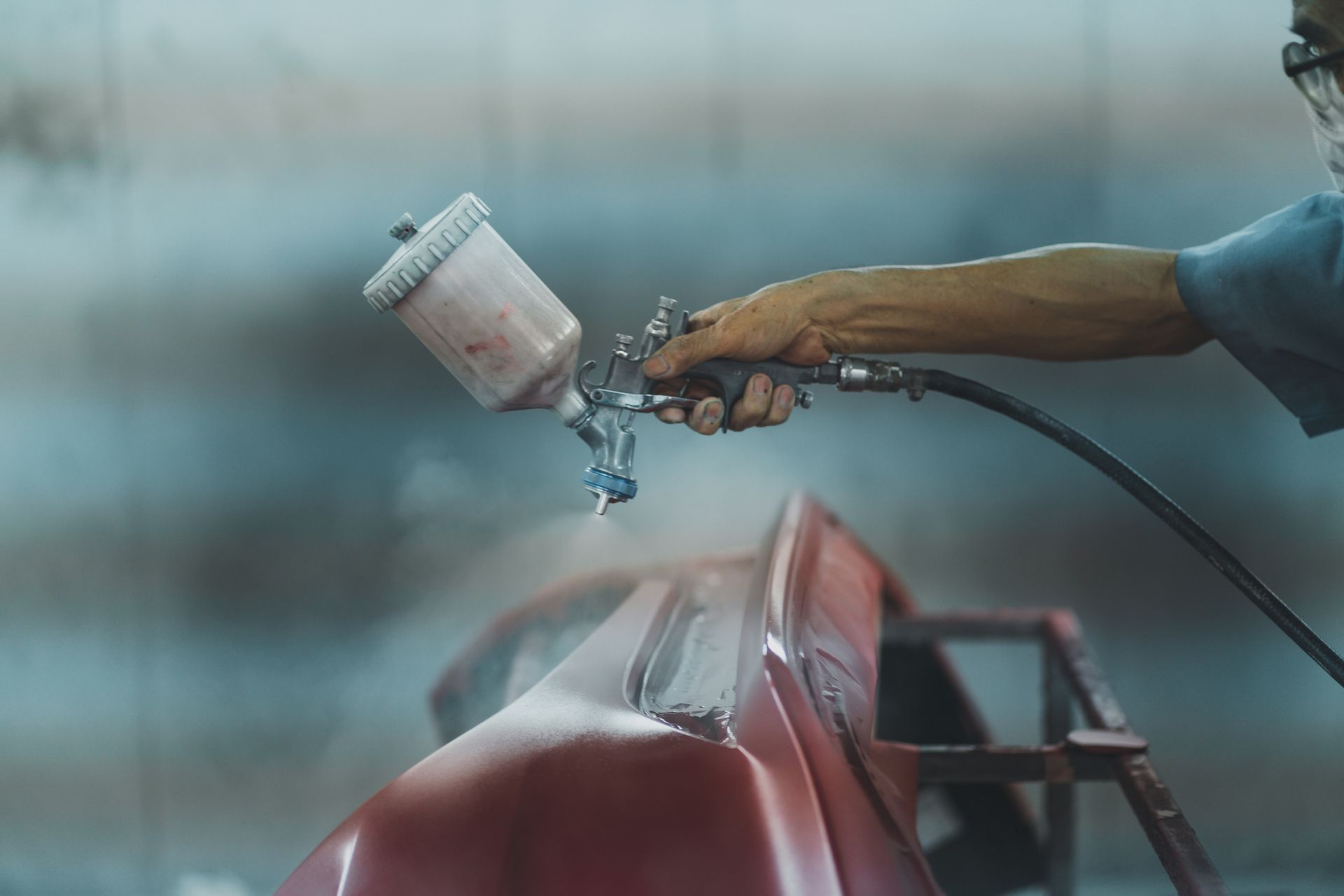 Man spray painting car