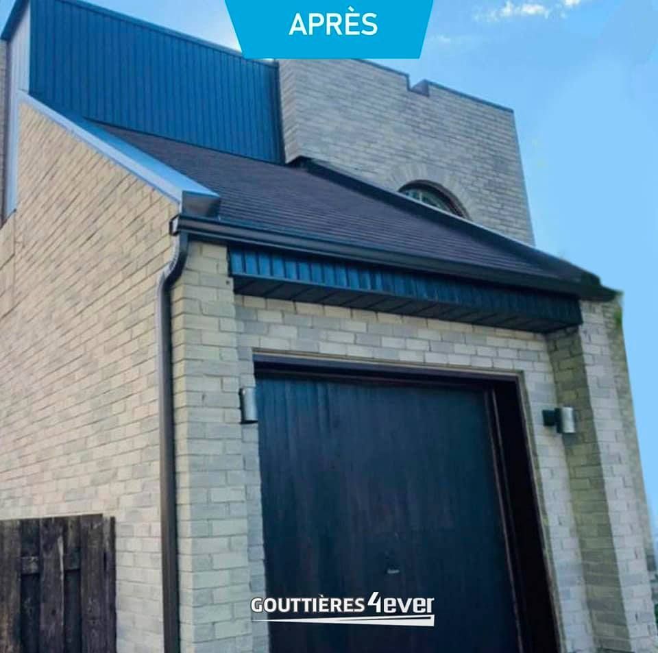 Un bâtiment en briques avec un toit bleu et une porte de garage noire
