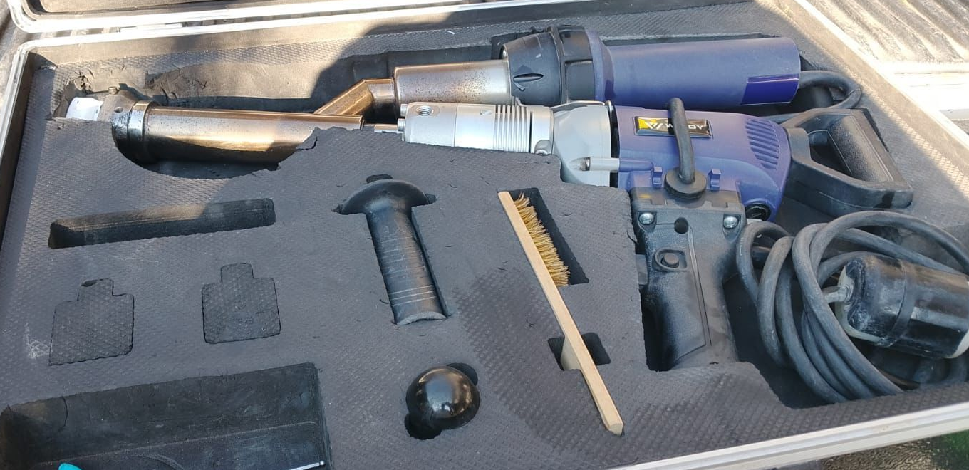 A blue and silver welding tool with accessories in a case.