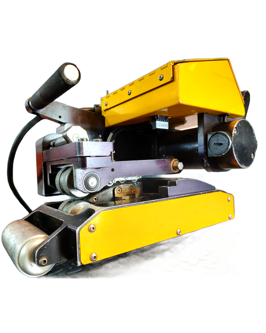 Yellow and black industrial machine with a roller, handle, and light.