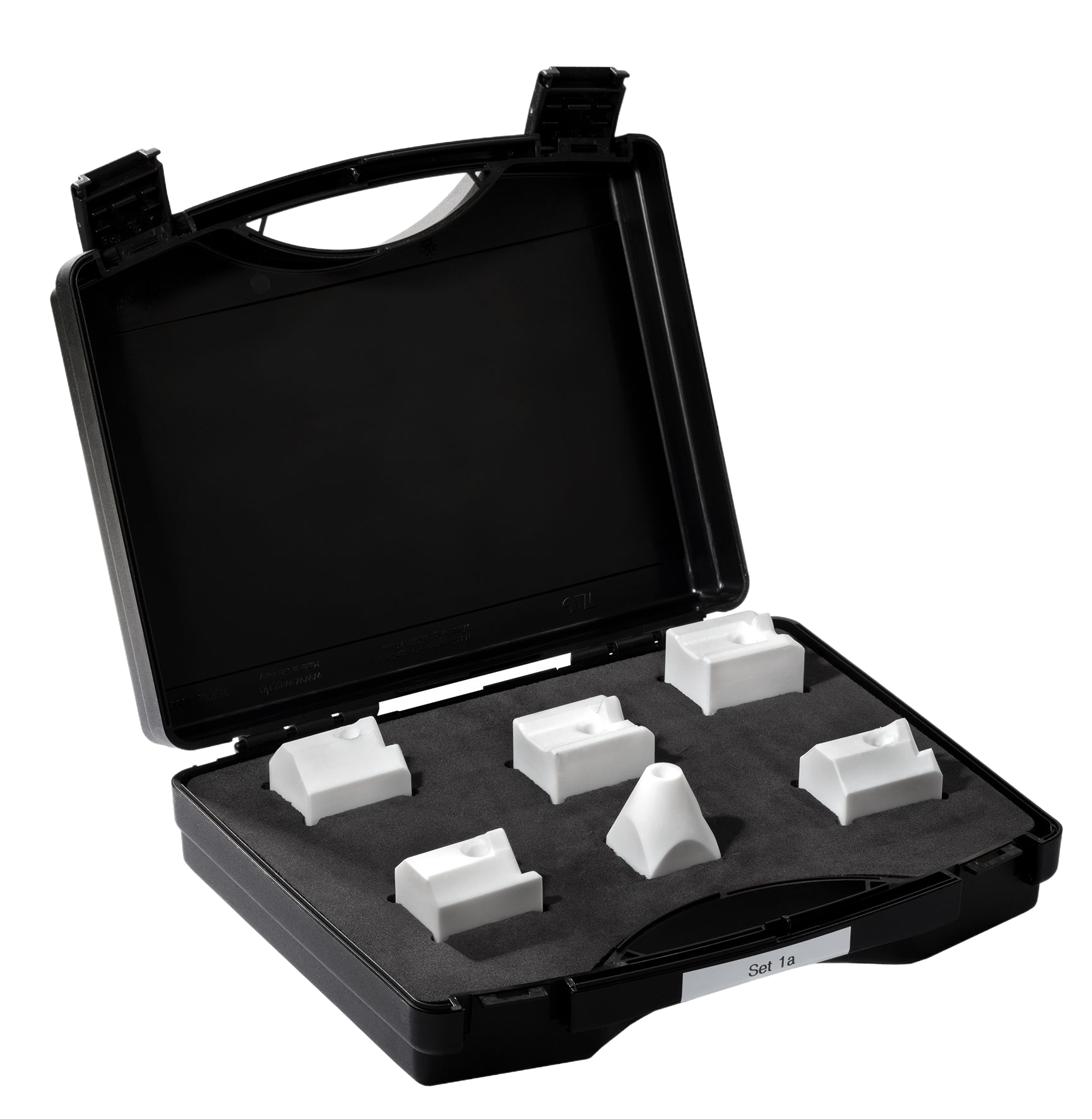 Black case open, containing six white geometric shapes set in foam padding.