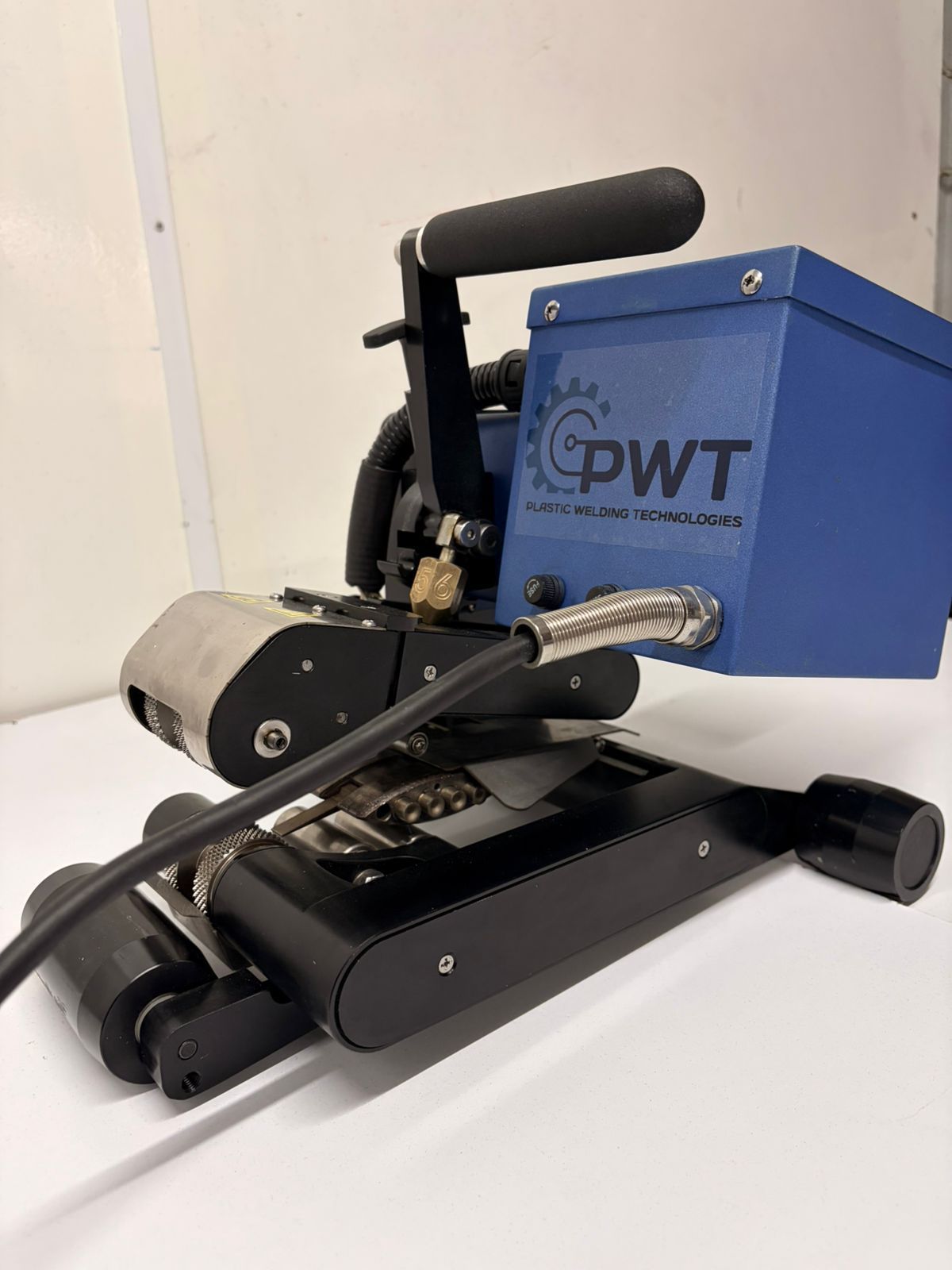 GWT portable industrial machine with black rollers and blue motor housing on a white surface