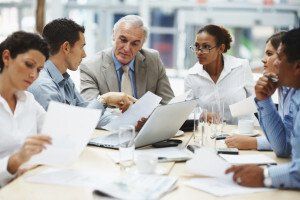 A team of professionals look over paperwork