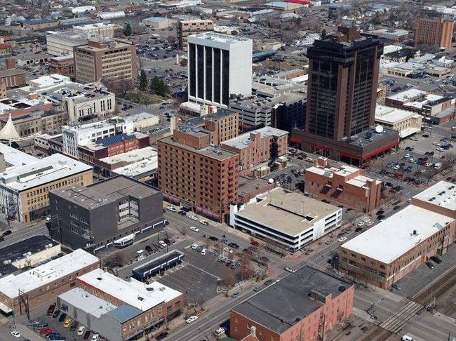 Aerial view of a downtown area with midrise buildings, streets, and snowy rooftops
