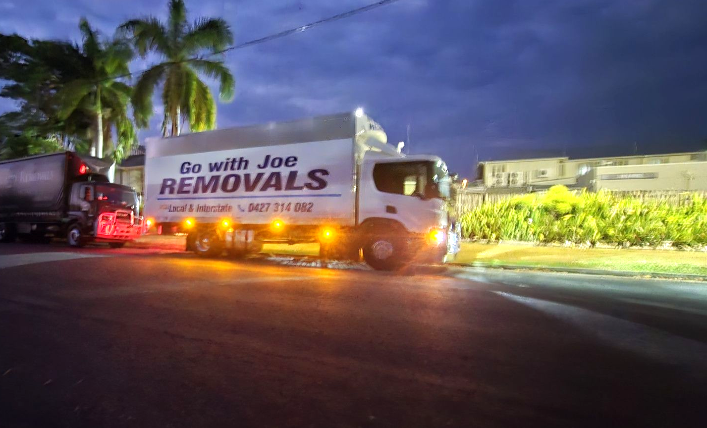 White Van With Open Back, Loaded With Cardboard Boxes, Parked on a Street — Go With Joe REMOVALS in Rockhampton, QLD