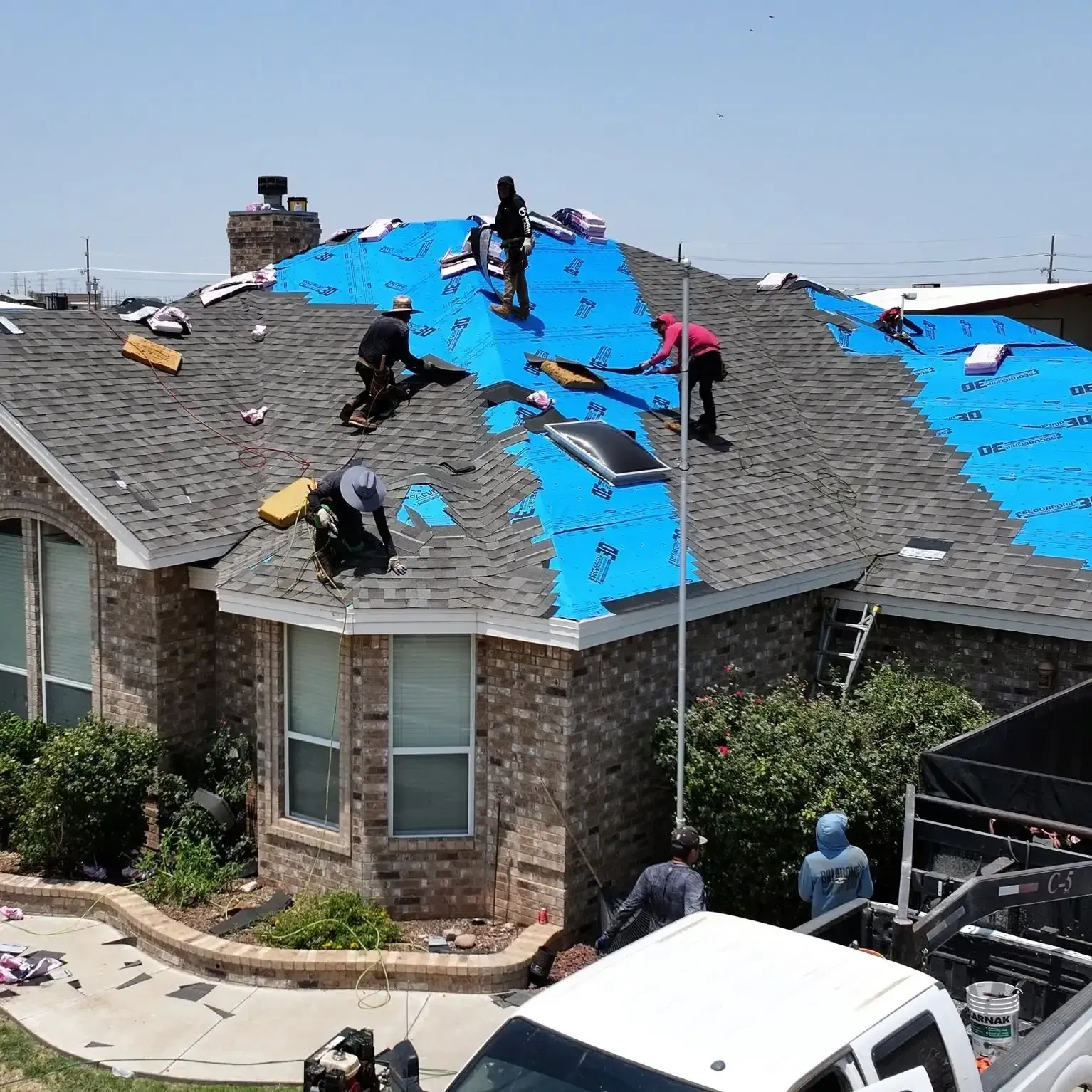 Grey asphalt shingle roof installation on residential home by Roofs by Nicholas in Texas