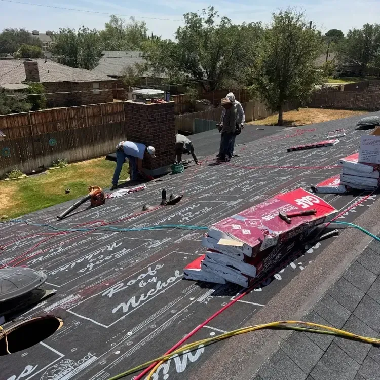 Brick home with shingle bundles loaded on the roof ahead of installation