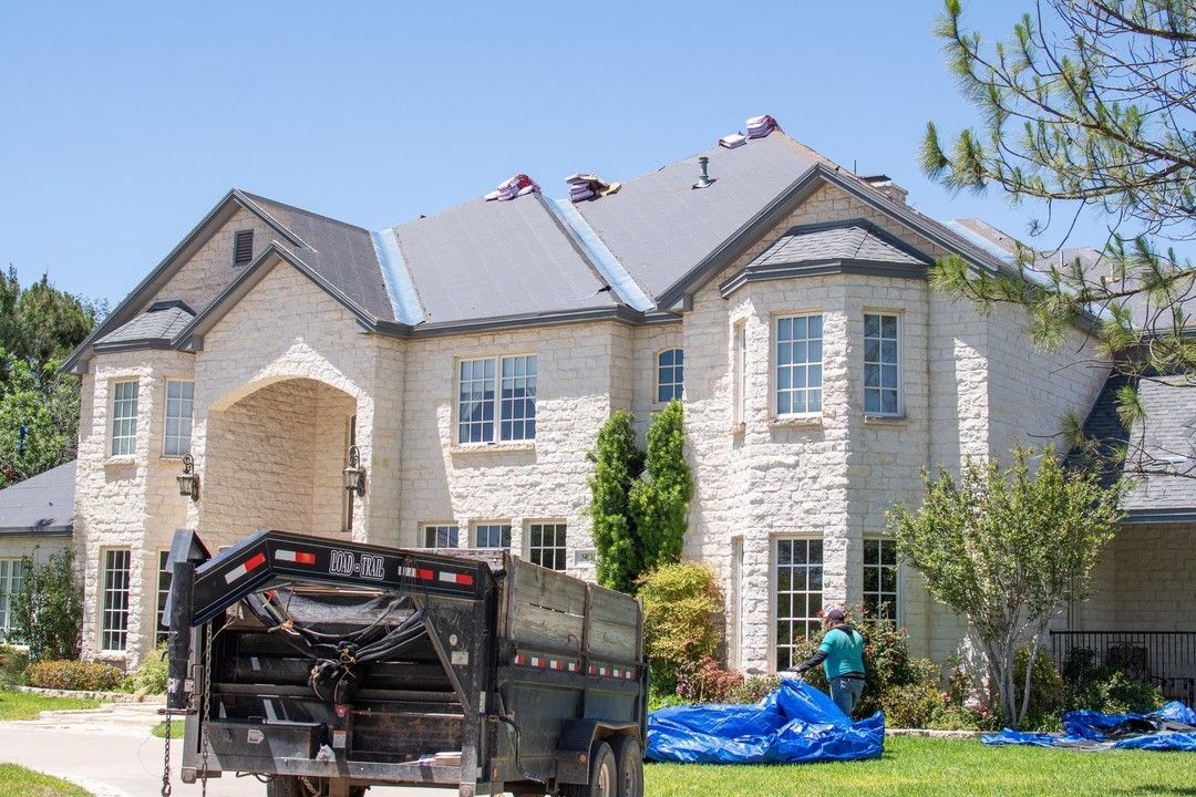 Large residential home with roof replacement in progress and underlayment installed