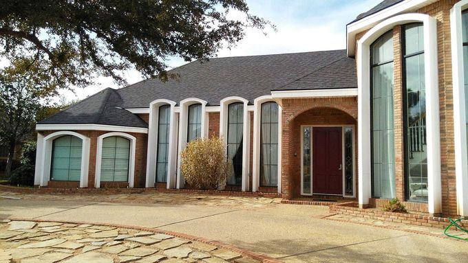 Large residential home with new dark shingle roof installation by Roofs by Nicholas