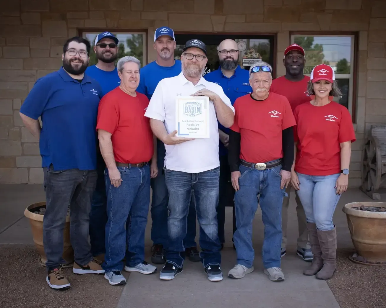 General Manager Greg Niehenke (center, white shirt) and the Roofs by Nicholas team holding the 2025 NewsWest 9 Best of the Basin award