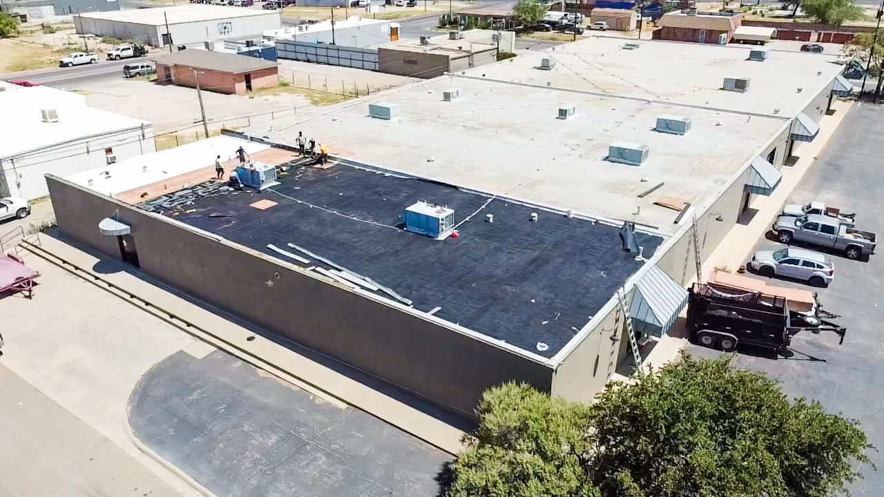 Commercial flat roof installation by roofing crew