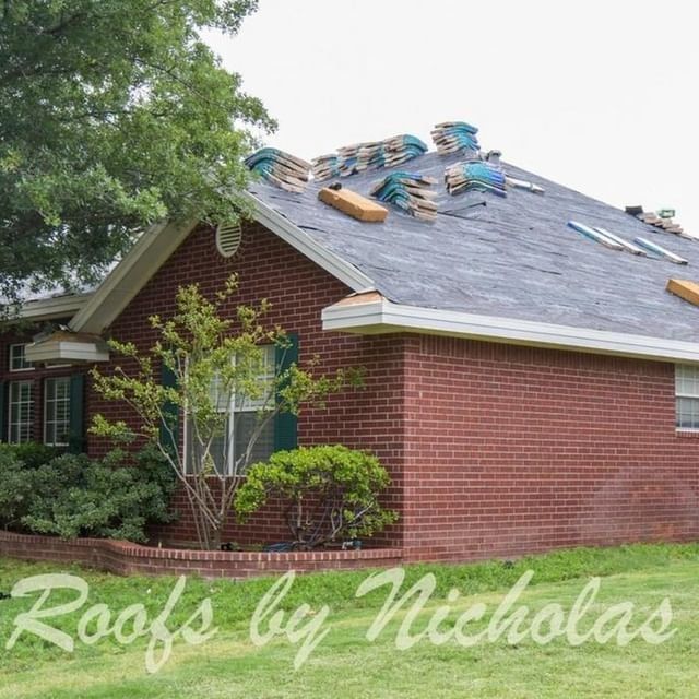 Residential roof replacement in progress with shingles removed