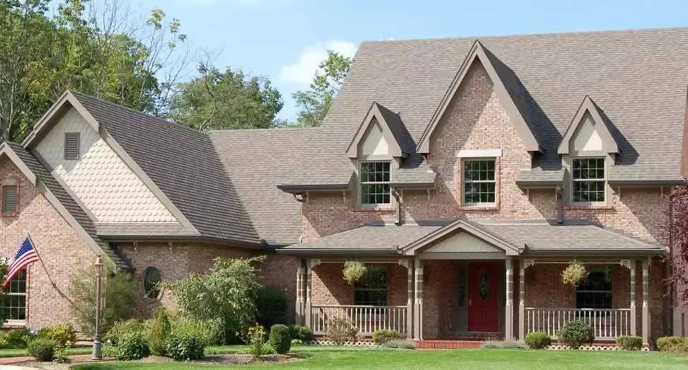 Beautiful brick house with new asphalt shingle roof by Roofs by Nicholas